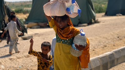 An internally displaced woman collecting drinking water in Jamshoro district of Pakistan's Sindh province. Flooding that submerged one third of the country and killed more than 1,000 people has piled pressure on its faltering economy. AFP