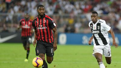 AC Milan's Cristian Zapata, left, runs with the ball past Juventus' Blaise Matuidi. AP Photo