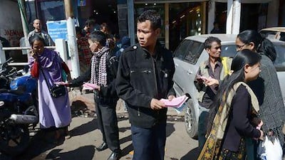 A member of Syngkhong Rympei Thymmai, a men's rights organisation, distributes leaflets promoting the organisation in Shillong. Roberto Schmidt / AFP