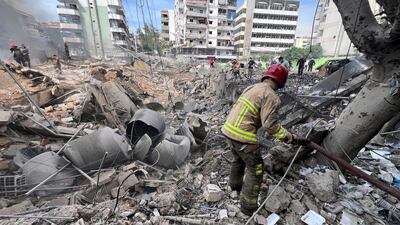 Firemen work on the site of an Israeli army strike in the suburb of Dahiye, Beirut, Friday March 28, 2025. AP Photo