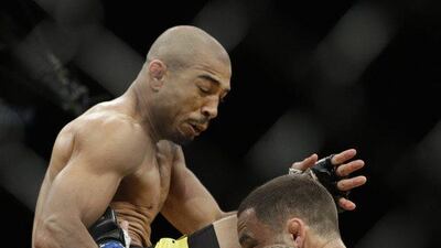 Jose Aldo, left, lands a knee to Frankie Edgar during their featherweight championship bout at UFC 200, Saturday, July 9, 2016, in Las Vegas. John Locher / AP Photo