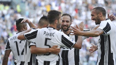 Juventus have used the money from the sale of Paul Pogba to Manchester United by arming themselves for an assault on the Uefa Champions League. Striker Gonzalo Higuain, centre right, has arrived, as well as midfielder Miralem Pjanic, centre, and full-back Dani Alves. Giorgio Perottino / Reuters