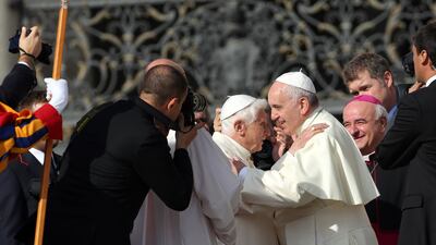 Pope Francis greets Pope Emeritus Benedict XVI at St Peter's Basilica in September 2014. Getty Images