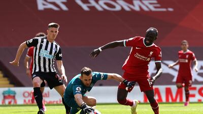 Newcastle goalkeeper Martin Dubravka saves at the feet of Liverpool's Sadio Mane at Anfield. Getty