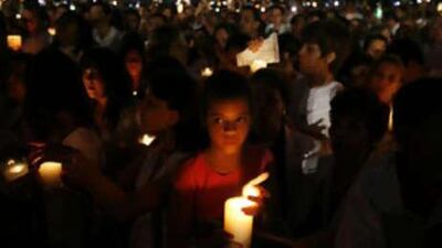 People hold candles at the Macroplaza in downtown Monterrey on Aug 30. Thousands of Mexicans dressed in white marched on Saturday to protest a wave of kidnappings and gruesome murders, putting pressure on the president Felipe Calderón, to meet his promises to crack down on crime.