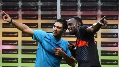Yuvraj Singh and Usain Bolt pose for a picture after their exhibition in front of fans in Bangalore on Tuesday. Manjunath Kiran / AFP