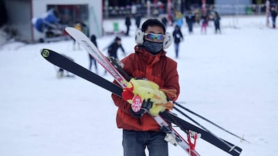 The duck is held aloft by its owner who clutches a red certificate of honour after it waddled over the finish line first.