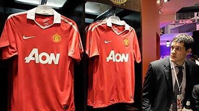 A fan inspects the new Manchester United home shirt during an unveiling ceremony at Niketown in Chicago as the English Premier League club prepare for their pre-season tour of north America, which kicks off with a match against Celtic in Toronto today.