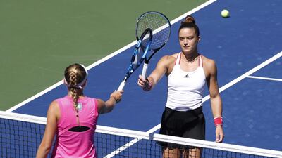 Maria Sakkari and Amanda Anisimova tap racquets at the net after their US Open third round match. EPA