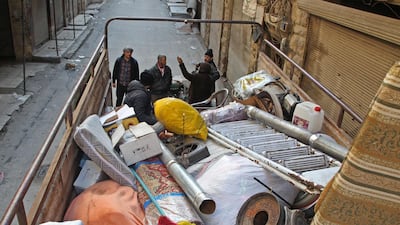 Syrians load their belongings into a truck before driving away from Maaret Al-Numan in the northwestern Idlib province. AFP