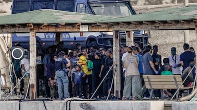 Migrant survivors stand on the dock after a shipwreck on the southern Italian island of Lampedusa, Italy, on Wednesday. Reuters