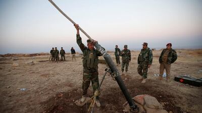Peshmerga forces prepare to launch a mortar during an operation to attack Islamic State militants in the town of Naweran near Mosul. Azad Lashkari / Reuters