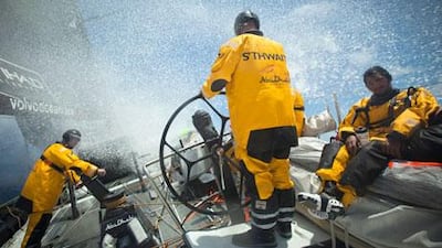 Craig Satterthwaite mans the helm as Abu Dhabi Ocean Racing's 'Azzam' slams through a wave as she makes her way to the secret port location to avoid pirates.