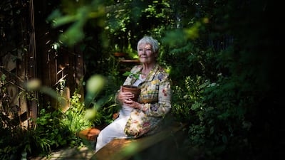 Dame Judi Dench holds a seedling in a pot from the Sycamore Gap tree in the Octavia Hill Garden by Blue Diamond. PA