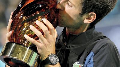 Novak Djokovic of Serbia kisses the trophy after winning the final match against South African Kevin Anderson at the Mubadala World Tennis Championship in 2018. EPA