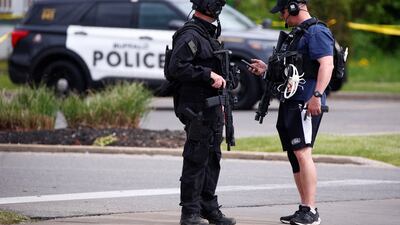 Police officers secure the scene after a shooting at TOPS supermarket in Buffalo. Reuters