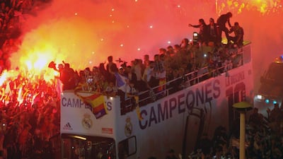 Real Madrid players on board the team bus celebrate their Champions League victory with fans at Cibeles Square in Madrid on Saturday night. Curto de la Torre / AFP / May 24, 2014