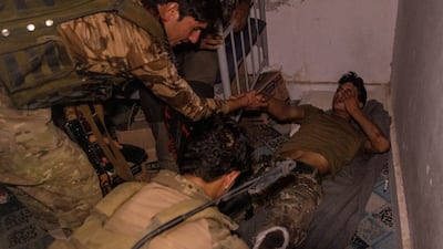 Afghan Special Forces tend to a soldier injured during a firefight with the Taliban during an attack on a district centre in Kandahar province, July 12, 2021.