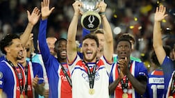 Khvicha Kvaratskhelia of Paris Saint-Germain lifts the Uefa Super Cup trophy. Getty Images