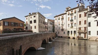 While many tourists use Treviso as a stop-off en route to Venice, it has many waterways of its own, plus portico-lined streets. Getty Images