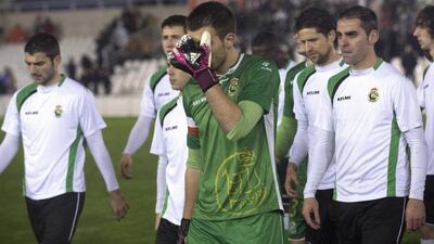 Racing Santander players leave the pitch after refusing to play at the start of their King's Cup quarter-final second leg against Real Sociedad on Thursday. Racing Santander's players, protesting over unpaid wages, refused to challenge for the ball after their quarter-final second leg at home to Real Sociedad kicked off. The third-tier team announced on Monday they would boycott the game unless club president Angel Lavin and the board resigned and they formed a line on the centre circle immediately after the match began. Nacho Cubero / Reuters