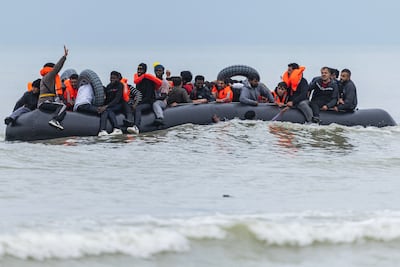Migrants crowd an inflatable dinghy in an attempt to cross the English Channel, after leaving Ecault beach in Saint-Etienne-au-Mont, northern France. AFP