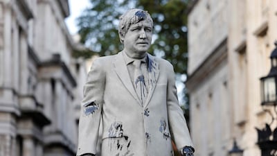 An oil-splattered, mock statue of British Prime Minister Boris Johnson by artist Hugo Farmer is installed by Greenpeace activists at Downing Street in London on Monday. AFP