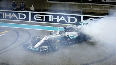 Nico Rosberg performs doughnuts in his Mercedes-GP car after winning the Formula One drivers' championship. Clive Mason / Getty Images