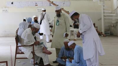 Pakistan pilgrims complete their travel documents at Hajj Complex in preparation to travel to Saudi Arabia to perform Hajj, Friday, Aug. 10, 2018 in Islamabad, Pakistan. A total of 185,000 Pakistanis will be performing the pilgrimage this year. AP