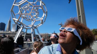 A woman watches the total solar eclipse outside the Exploratorium in San Francisco, California. AP