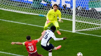 Switzerland captain Granit Xhaka makes a vital challenge on Kobbie Mainoo to stop the England midfielder shooting on goal. PA