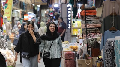 People walk in Tehran's Tajrish Bazaar on Thursday after the ceasefire between Iran and Israel. Reuters
