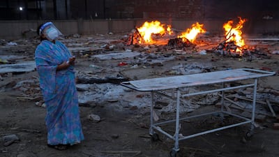A woman cries during the cremation of her husband, who died of Covid-19, at a crematorium in New Delhi. Reuters