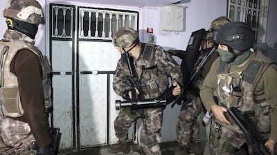 Turkish antiterrorism police break a door during an operation to arrest people over alleged links to ISIL, in Adiyaman, southeastern Turkey, on Sunday, February 5, 2017. Mahir Alan / Dha-Depo Photos via AP