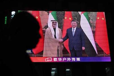 News footage on a screen outside a shopping mall shows Abu Dhabi Crown Prince Sheikh Khaled bin Mohamed meeting the Chinese president, Xi Jinping, in Beijing. Photo: AFP