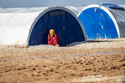 A Syrian woman sits by a tent in Washukanni camp, on December 16, 2019. Delil Souleiman / AFP