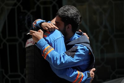 Colleagues of paramedic Mahdi Abu Zaid, who was killed in an Israeli strike, grieve during his funeral in Nabatieh. Reuters