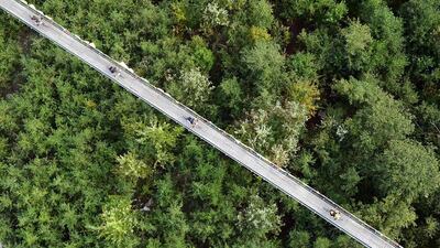 Riders in action on a pedestrian bridge during the third stage of the Swiss Epic Race on Wednesday. Laurent Ruchat / EPA