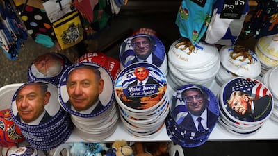 Kippahs bearing portraits of Israel's Prime Minister Benjamin Netanyahu, Otzma party leader Itamar Ben Gvir and US President Donald Trump, on display at a shop in Jerusalem. AFP