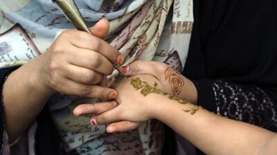 A woman has her hand painted with henna during Africa Day celebrations on Saturday. Delores Johnson / The National