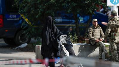 An orthodox Jewish pilgrim passes Ukrainian soldiers at a checkpoint near the tomb of Rabbi Nachman during Rosh Hashanah in Uman. EPA