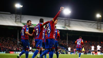 Dwight Gayle of Crystal Palace celebrates with teammates after scoring their first goal from a penalty on Saturday in their win over Tottenham. Julian Finney / Getty Images