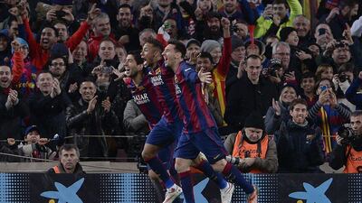 Barcelona's Lionel Messi, near, Neymar, centre, and Luis Suarez, far, celebrate after one of the team's three goals on Sunday in a 3-1 La Liga victory over Atletico Madrid. Josep Lago / AFP / January 11, 2015