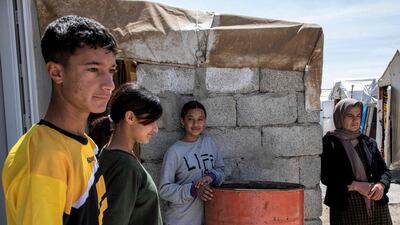 Now in a camp for displaced people, the 40-year-old said she has her 'eyes glued to the road' in the hope that her husband and son will return