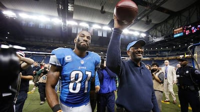 Detroit Lions wide receiver Calvin Johnson and his father Calvin Snr walk off the field after Johnson broke the single-season record for receiving yards. Pic: Duane Burleson / AP