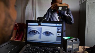 A National Register of Citizens officer takes a photograph of the eyes of a boy at an NRC centre on the eve of the release of the final list in Guwahati. AP Photo