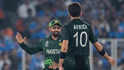Pakistan's captain Babar Azam celebrates with Shaheen Afridi after the dismissal of India's captain Rohit Sharma. AFP
