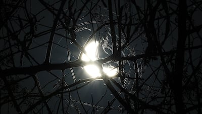 The partial eclipse appears over the UAE at Al Qudra Lakes, Dubai. Chris Whiteoak / The National