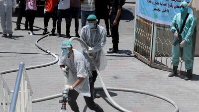Gazan security forces spray disinfectant during a simulation exercise for preventing the spread of the coronavirus in the Palestinian territory. Reuters