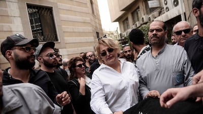 Mourners surround his coffin at the Abasiyeen Hospital, in Damascus